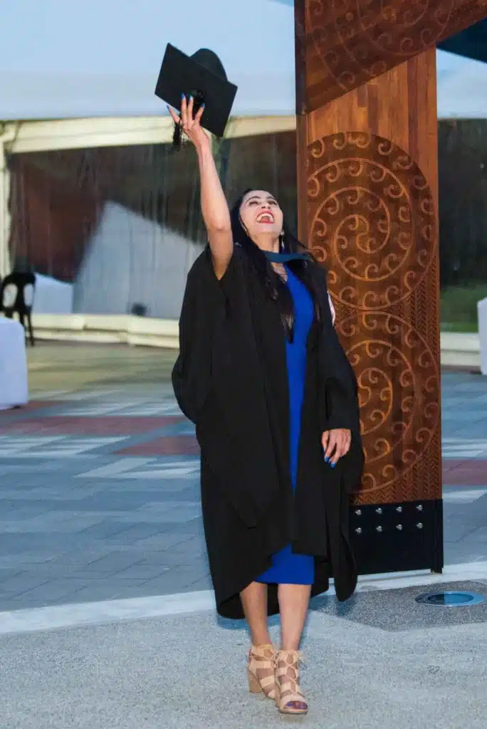 A proud graduate posing for their graduation ceremony photography